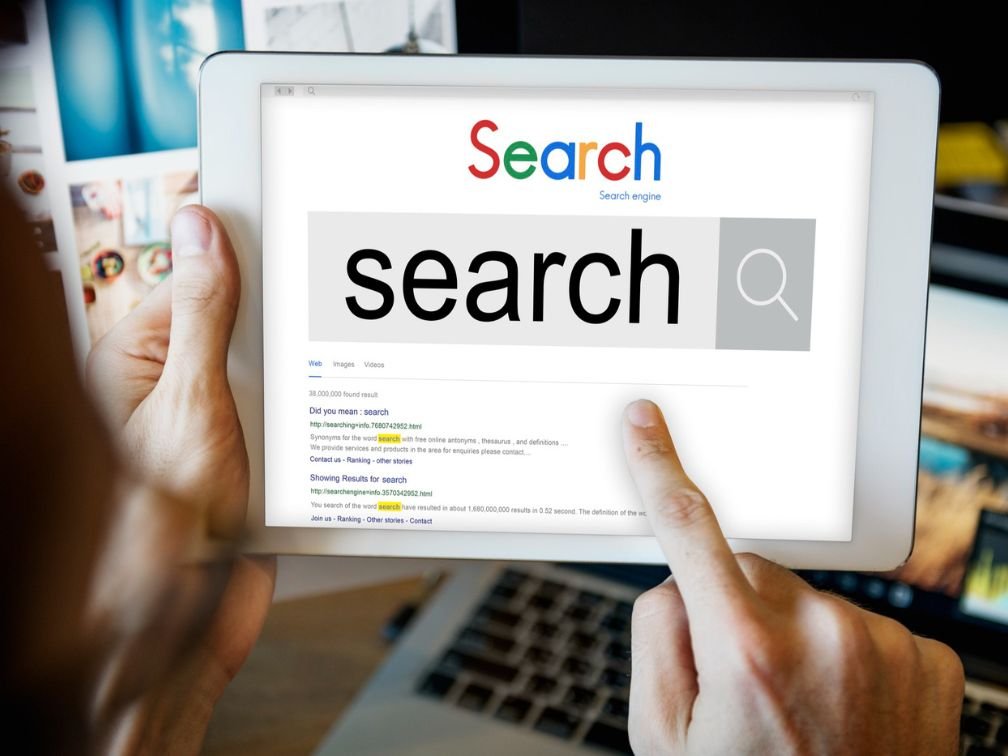 Keyword research concept, digital marketing, SEO strategy, search engine optimization, data analysis, charts, magnifying glass, keywords on screen, professional working on finding target keywords, laptop, and search tools