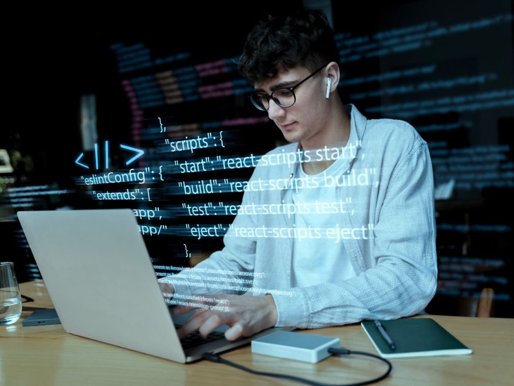 Realistic web app development scene, developer working on coding a web application, laptop with visible code on screen, user interface design, modern workspace with tech tools, software development, digital coding environment